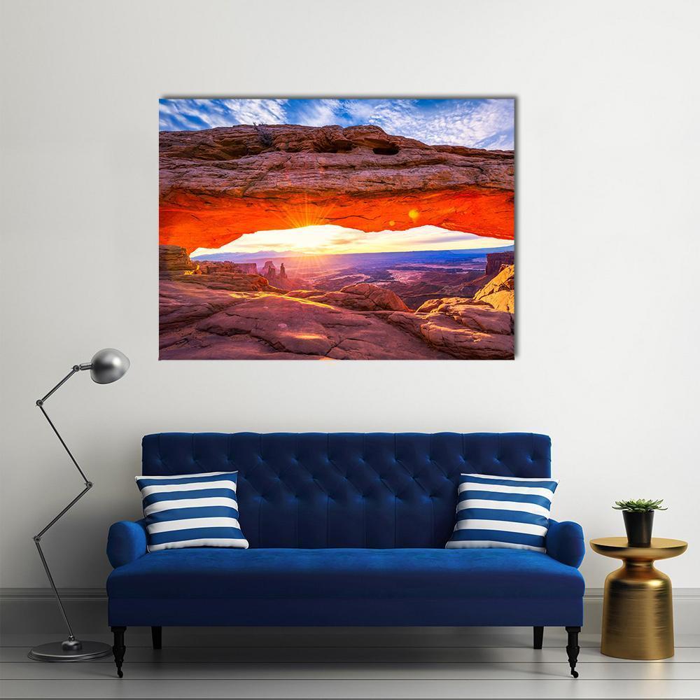 Mesa Arch at Sunrise Canvas Wall Art in brown, orange and blue, single panel hung on a wall