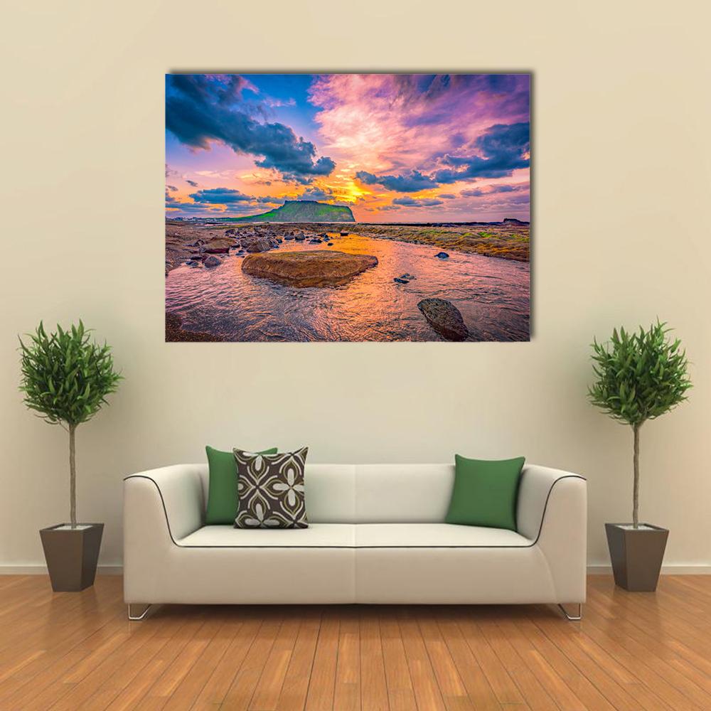 Sunset Over Rocky Shore and Tuff Cone Canvas Wall Art in orange, blue and purple, single panel hung on a wall