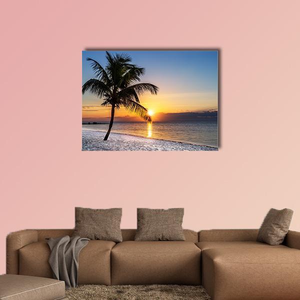 Golden Hour Beach Palm Silhouette Canvas Wall Art in orange, yellow and blue, single panel hung on a wall