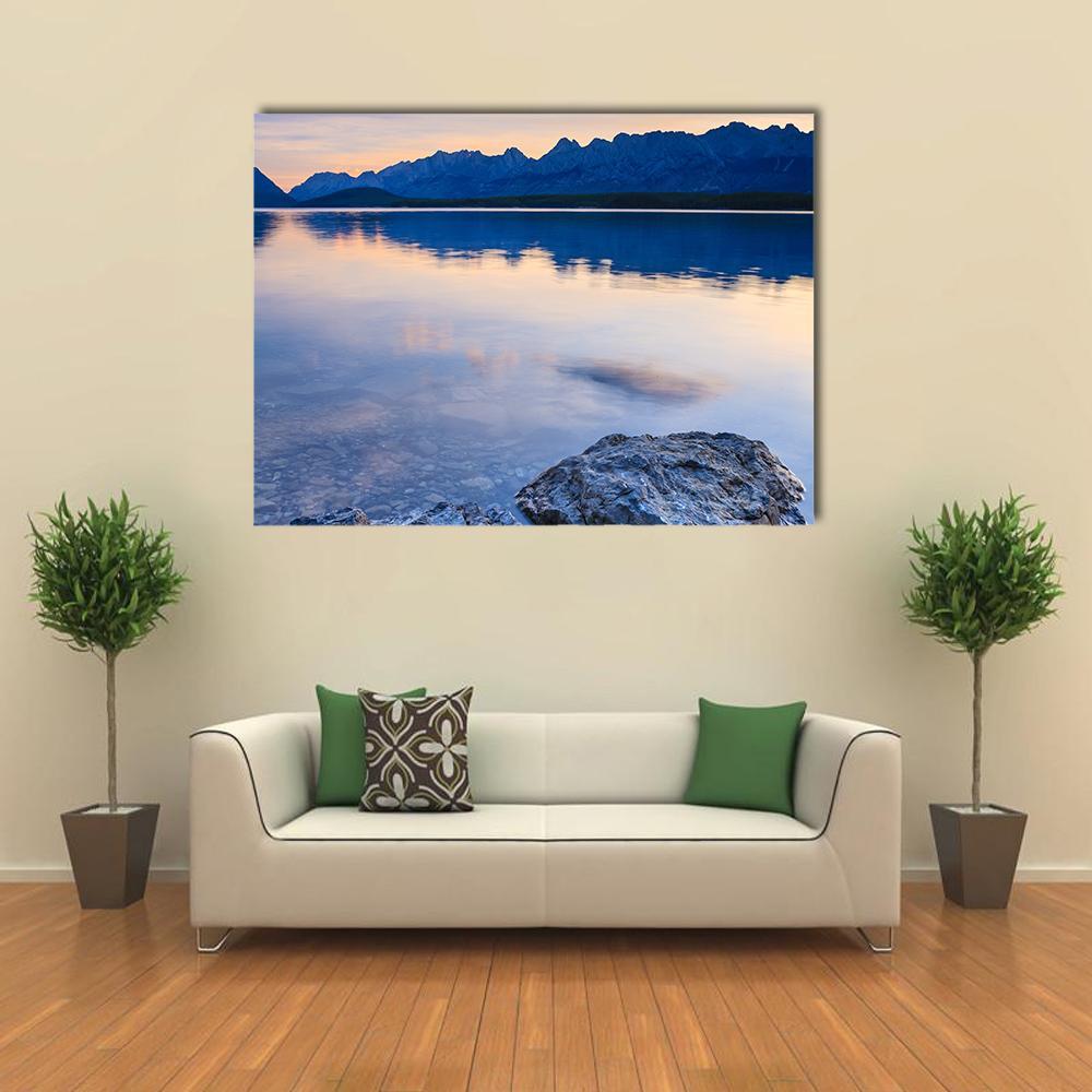 Lower Kananaskis Lake Sunrise Canvas Wall Art in orange and blue, single panel hung on a wall