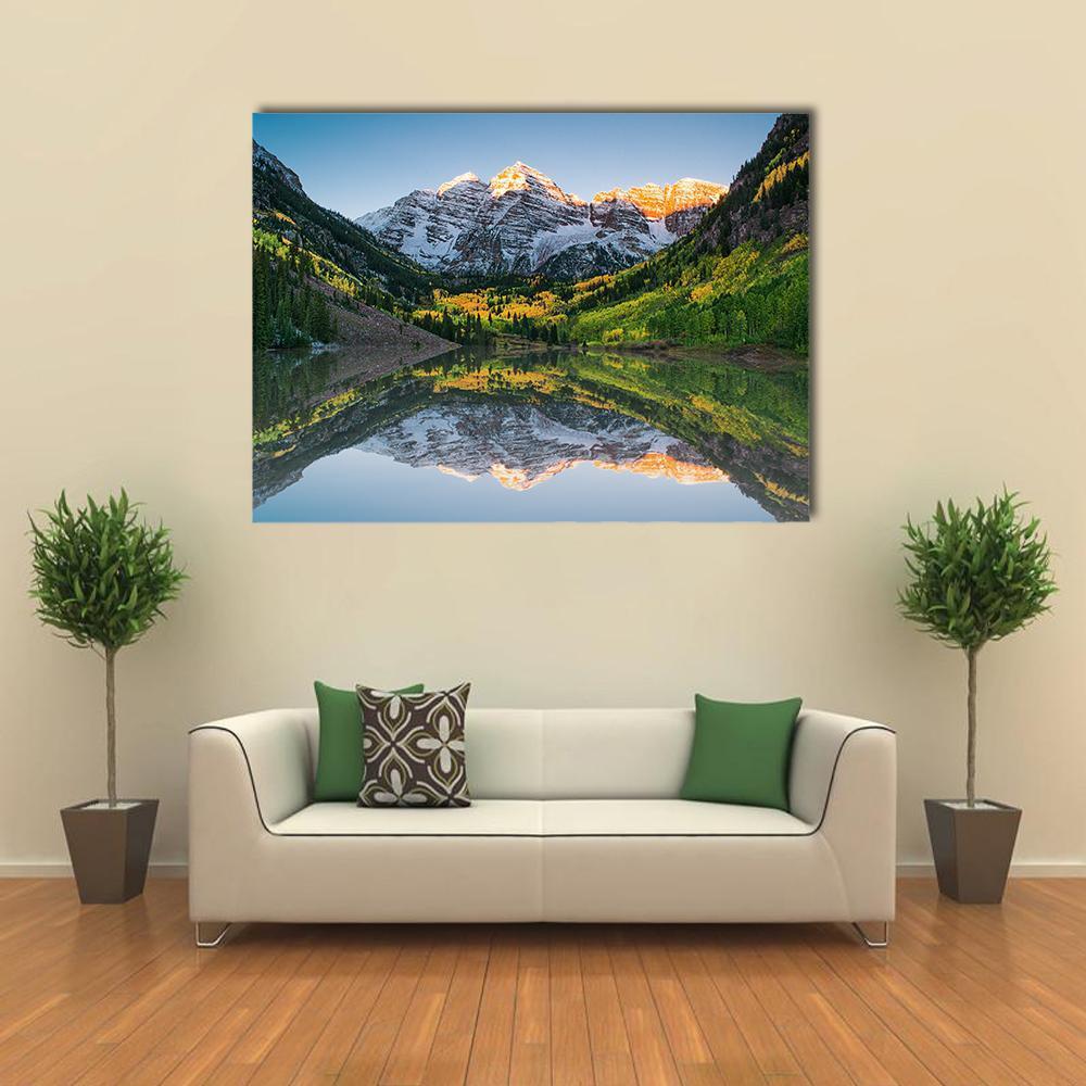 Sunrise at Maroon Bells Lake Canvas Wall Art in orange, green and blue, single panel hung on a wall