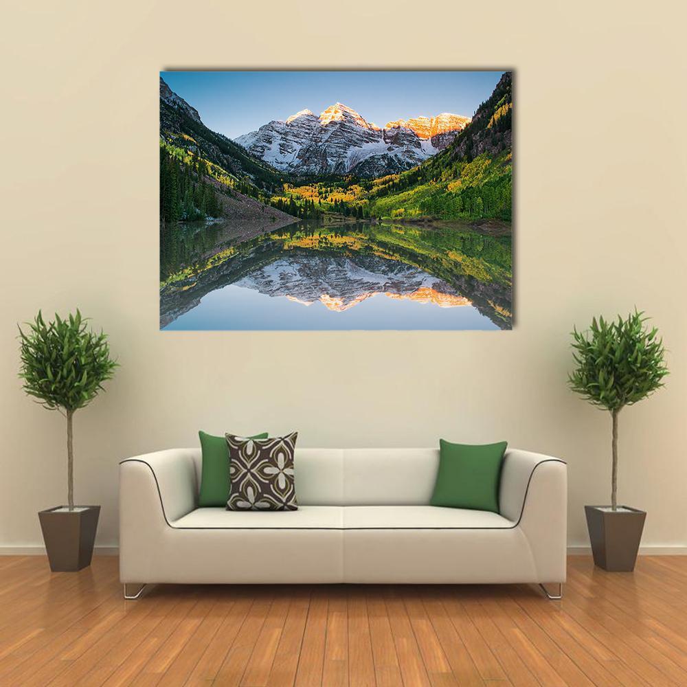 Sunrise at Maroon Bells Lake Canvas Wall Art in orange, green and blue, single panel hung on a wall