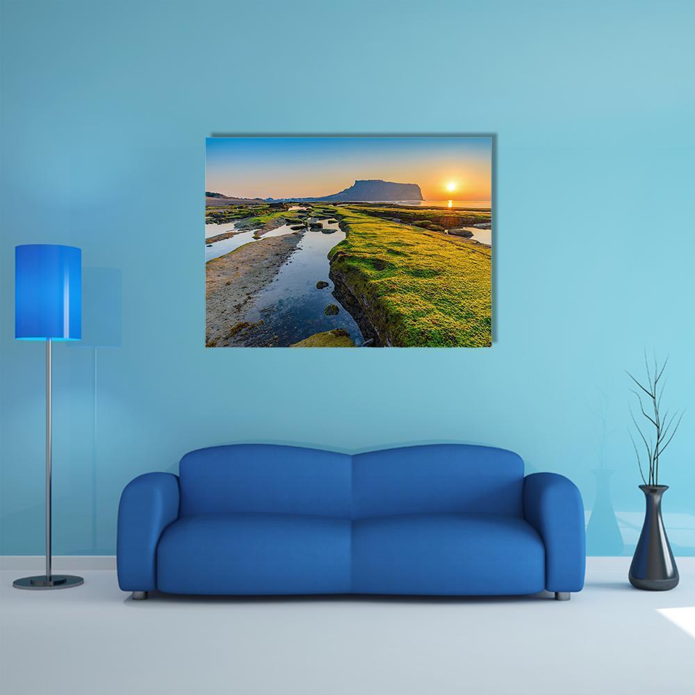 Sunrise at Seongsan Ilchulbong Canvas Wall Art in yellow, green and blue, single panel hung on a wall