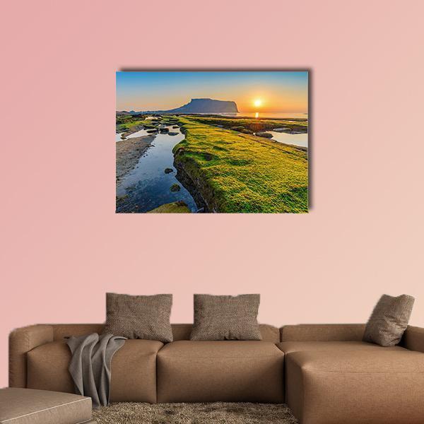 Sunrise at Seongsan Ilchulbong Canvas Wall Art in orange, green and blue, single panel hung on a wall