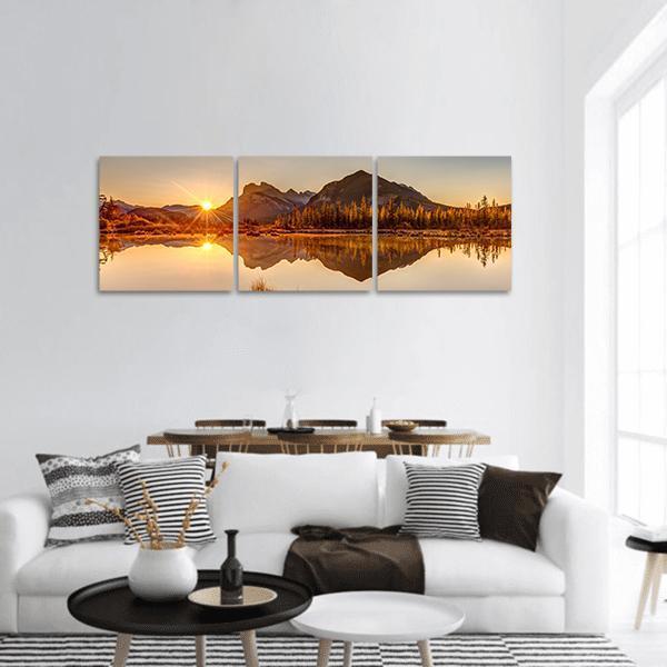 Sunrise at Vermilion Lakes Panoramic Canvas Wall Art in brown, orange and yellow, hung on a wall