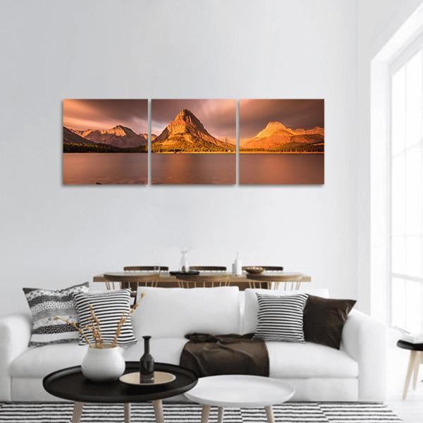 Mount Grinnell at Sunrise Panoramic Canvas Wall Art in brown, orange and pink, hung on a wall