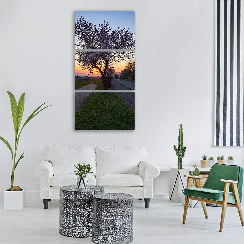 Spring Pathway at Sunset Vertical Canvas Wall Art in orange, green and purple, hung on a wall