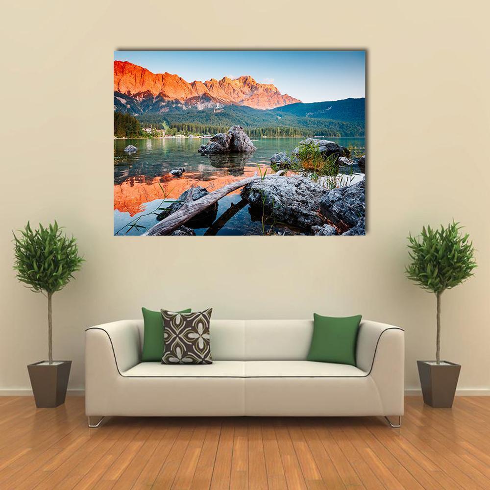 Sunrise on Lake Eibsee Canvas Wall Art in gray, orange and blue, single panel hung on a wall
