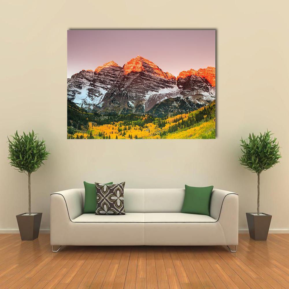 Sunrise Over Maroon Bells Canvas Wall Art in orange, yellow and pink, single panel hung on a wall