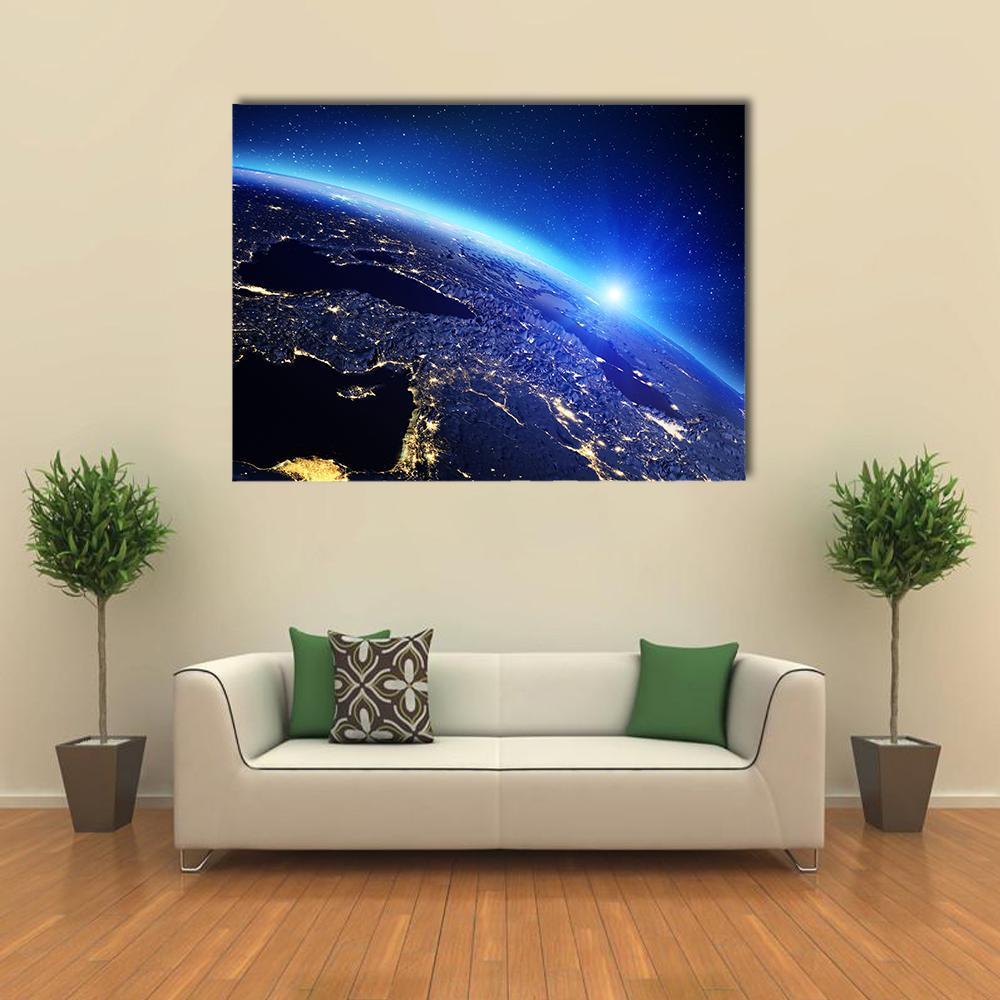 Sunrise Over Earth with City Lights Canvas Wall Art in black, blue and navy, single panel hung on a wall