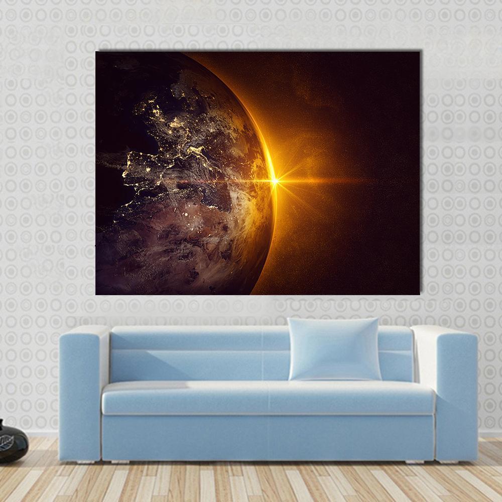 Sunrise on Planet Earth Canvas Wall Art in black, gold and orange, single panel hung on a wall