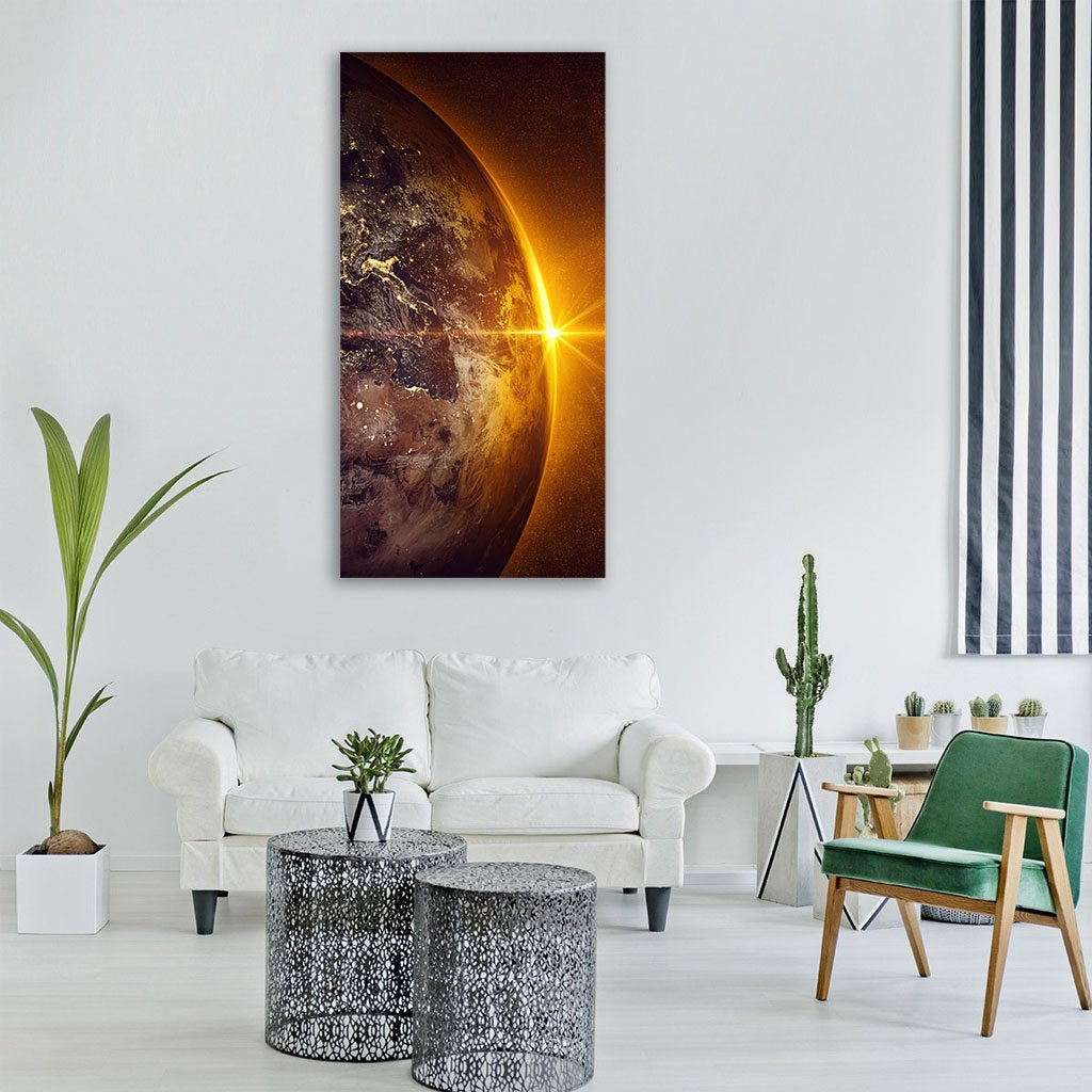 Sunrise Over Earth from Space Vertical Canvas Wall Art in black, gold and orange, single vertical panel hung on a wall