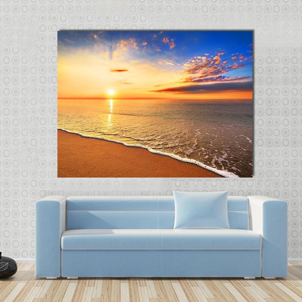 Sunrise on the Beach Canvas Wall Art in orange, yellow and blue, single panel hung on a wall