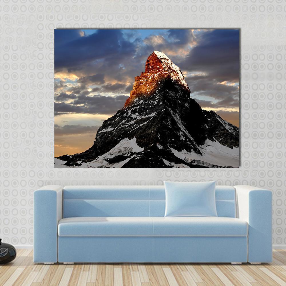 Sunrise on the Matterhorn Canvas Wall Art in black, orange and blue, single panel hung on a wall