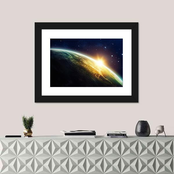 Sunrise on the Planet from Space Canvas Wall Art in black, yellow and blue, framed print, product view on a white background