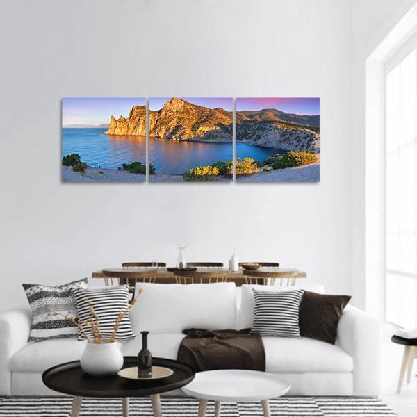 Summer Sunrise at Royal Bay Panoramic Canvas Wall Art in brown, yellow and blue, hung on a wall