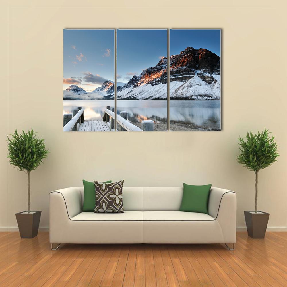 Sunrise Over Bow Lake in Banff National Park Canvas Wall Art in white, orange and blue, 3 panel horizontal set hung on a wall