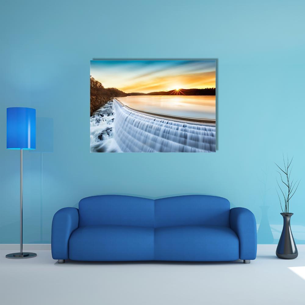 Sunrise Over Croton Dam Canvas Wall Art in orange, yellow and blue, single panel hung on a wall