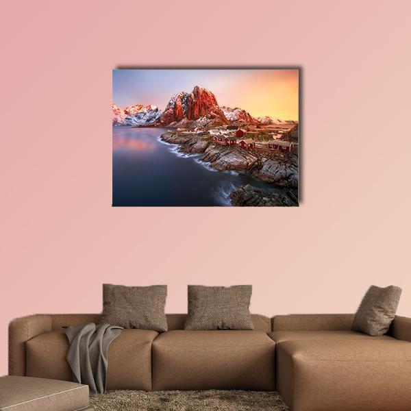 Sunrise Over Red Rorbu Cabins Canvas Wall Art in red, orange and blue, single panel hung on a wall