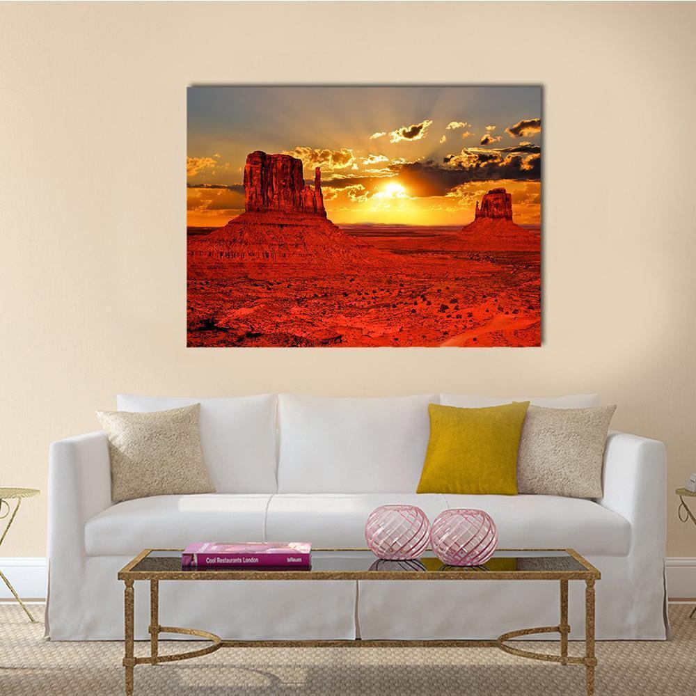 Sunrise Over Monument Valley Canvas Wall Art in red, orange and yellow, single panel hung on a wall