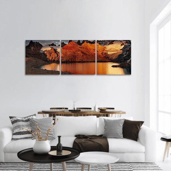 Mount Fitz Roy at Sunrise Panoramic Canvas Wall Art in black, brown and orange, hung on a wall