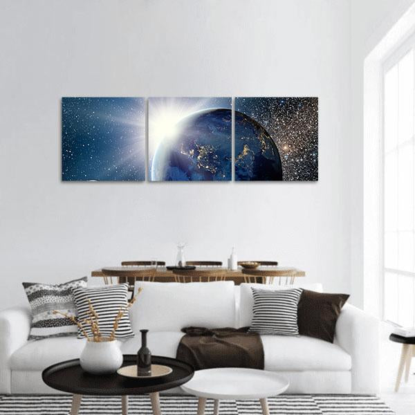 Orbital Sunrise Over Earth Panoramic Canvas Wall Art in black, white and blue, hung on a wall