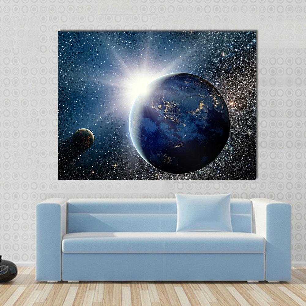 Cosmic Sunrise Over Earth Canvas Wall Art in black, white and blue, single panel hung on a wall
