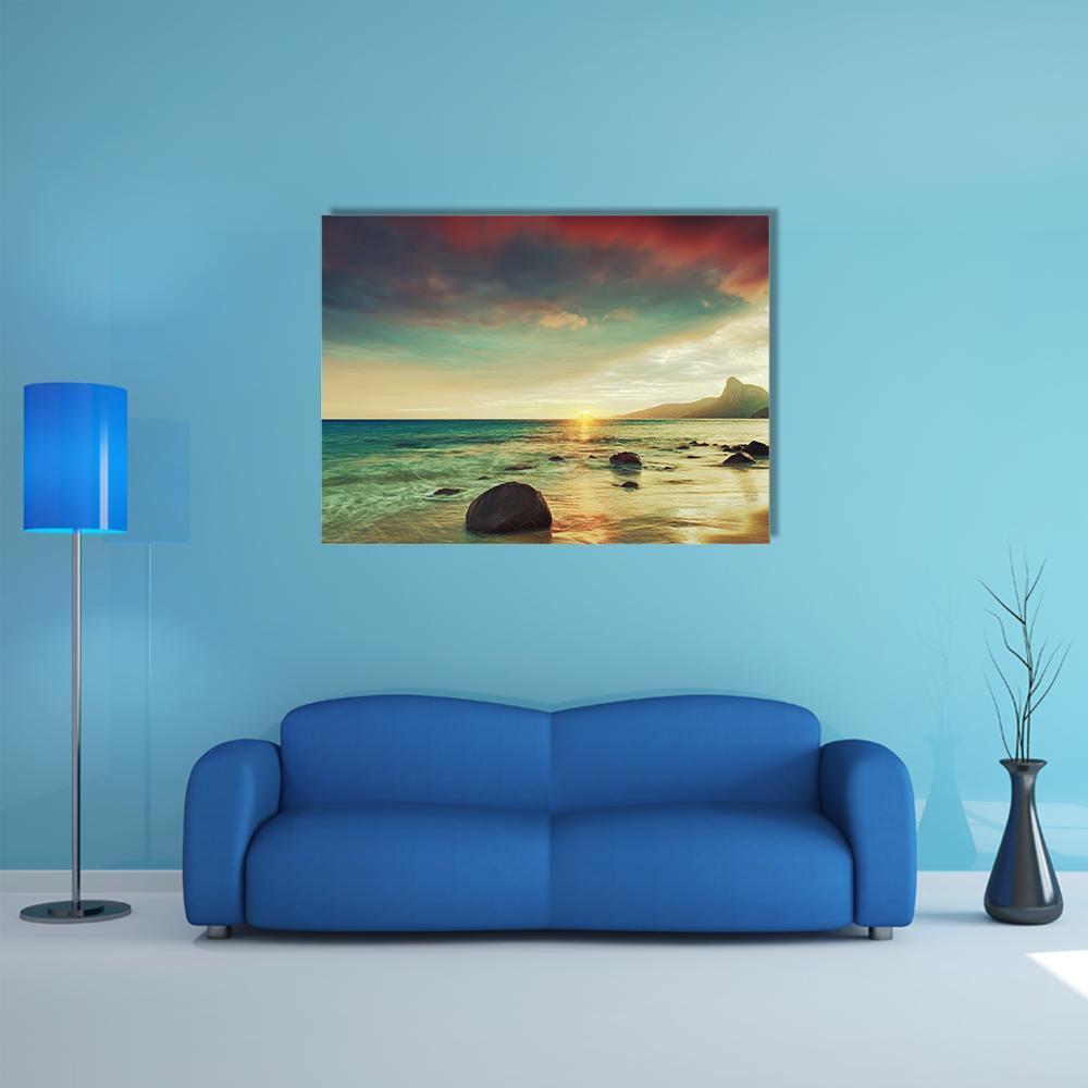 Sunrise Over the Sea Canvas Wall Art in orange, yellow and blue, single panel hung on a wall