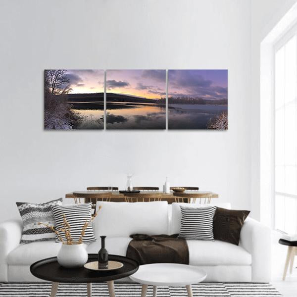 Sunrise Over Winter Lake Panoramic Canvas Wall Art in white, orange and purple, hung on a wall