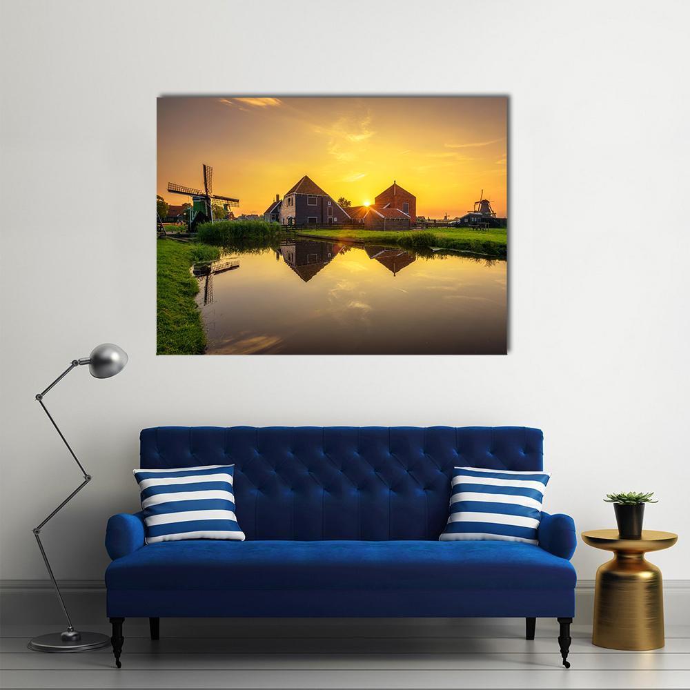 Dutch Sunset Over Farmhouses and Windmills Canvas Wall Art in brown, orange and yellow, single panel hung on a wall