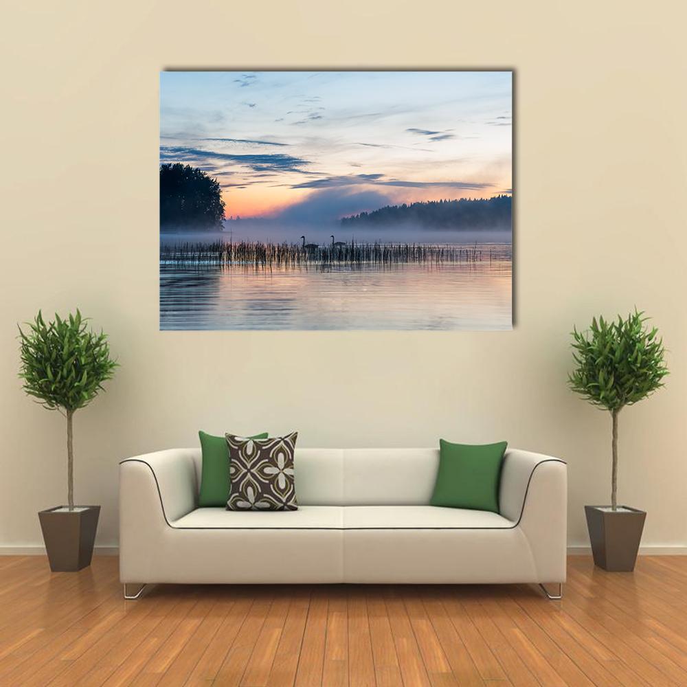 Sunset and Fog Over Finnish Lake Canvas Wall Art in gray, orange and blue, single panel hung on a wall