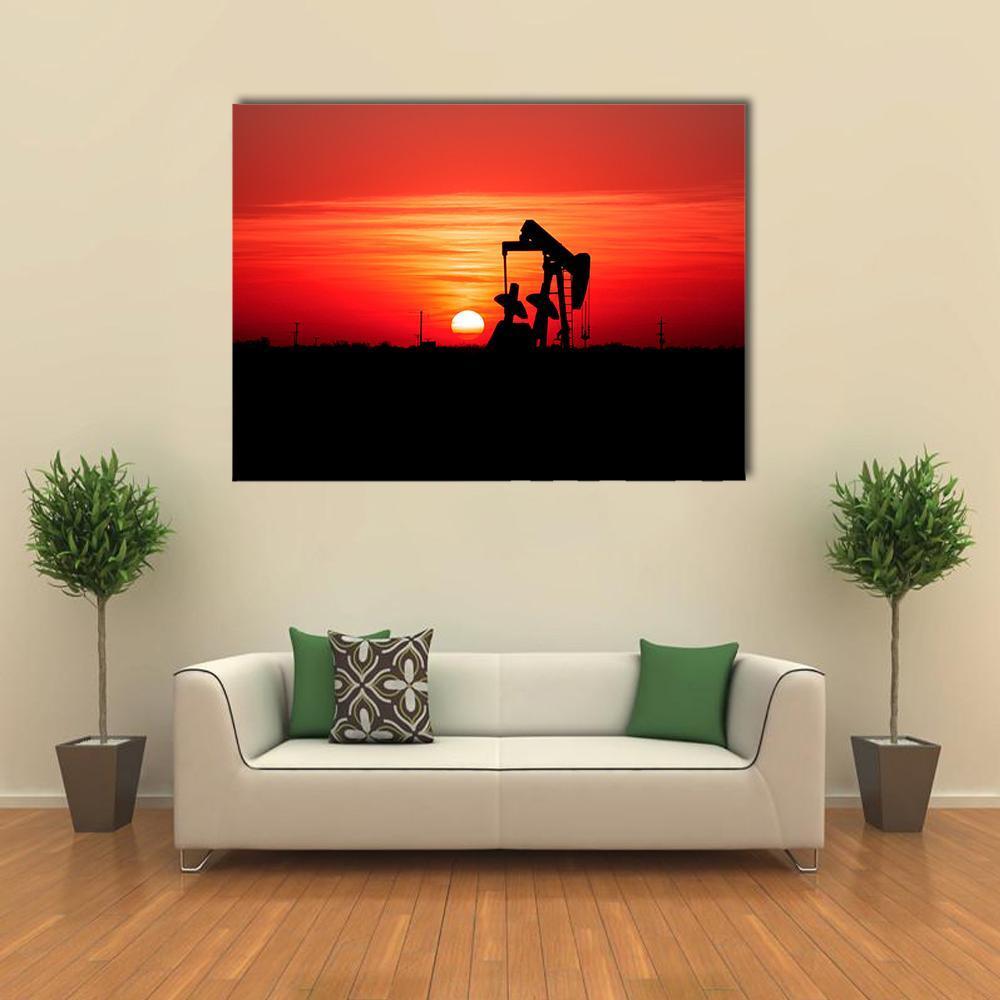 Silhouetted Oil Pump Jack at Sunset Canvas Wall Art in black, red and orange, single panel hung on a wall