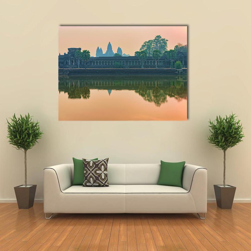 Sunset Reflection at Angkor Wat Canvas Wall Art in orange, green and pink, single panel hung on a wall