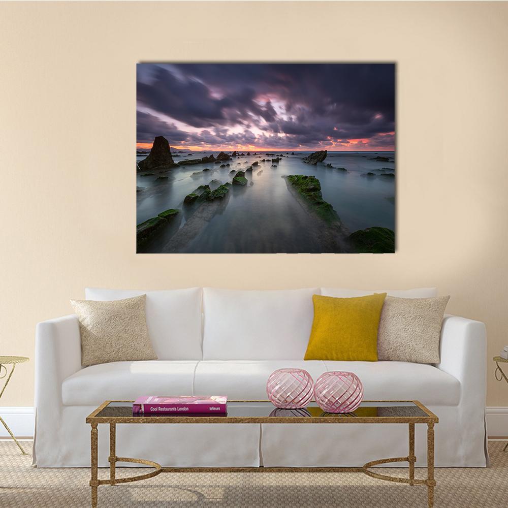 Misty Rocky Coast at Sunset Canvas Wall Art in gray, orange and purple, single panel hung on a wall