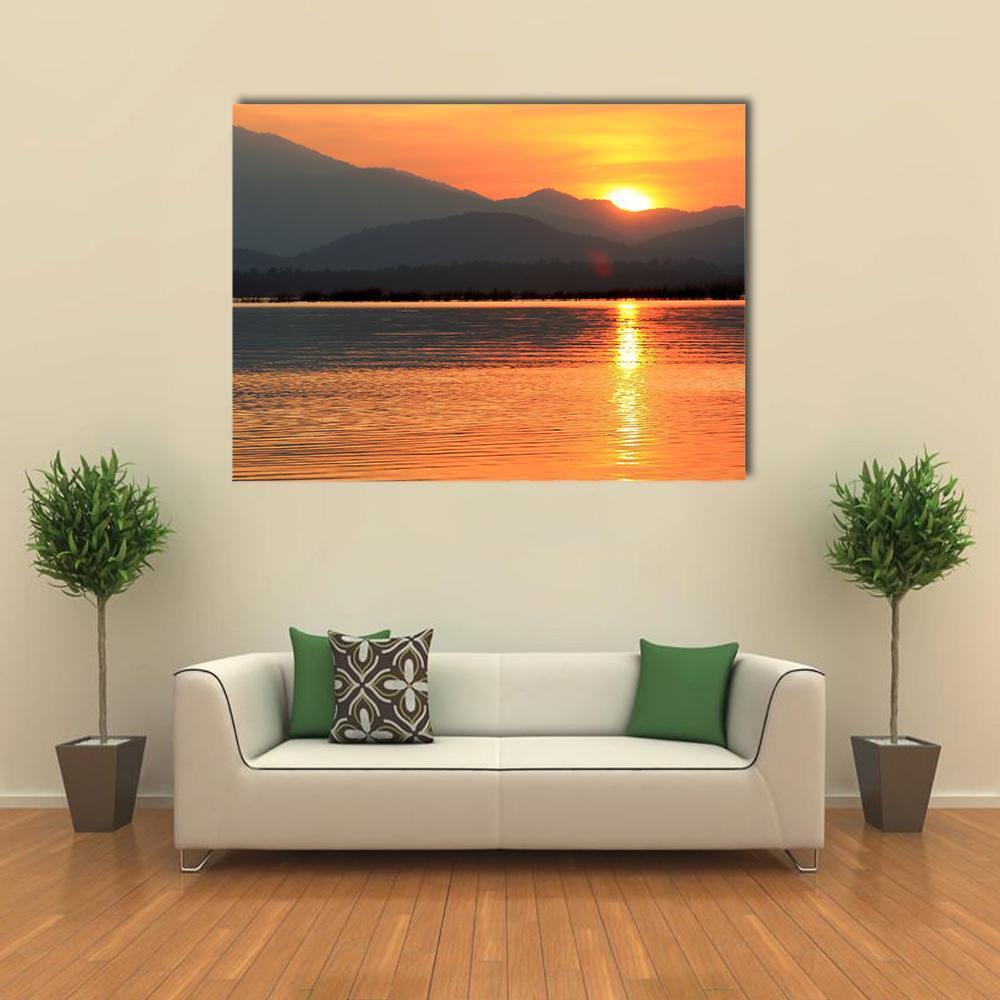 Sunset Over Mountain Lake Canvas Wall Art in gray, orange and yellow, single panel hung on a wall