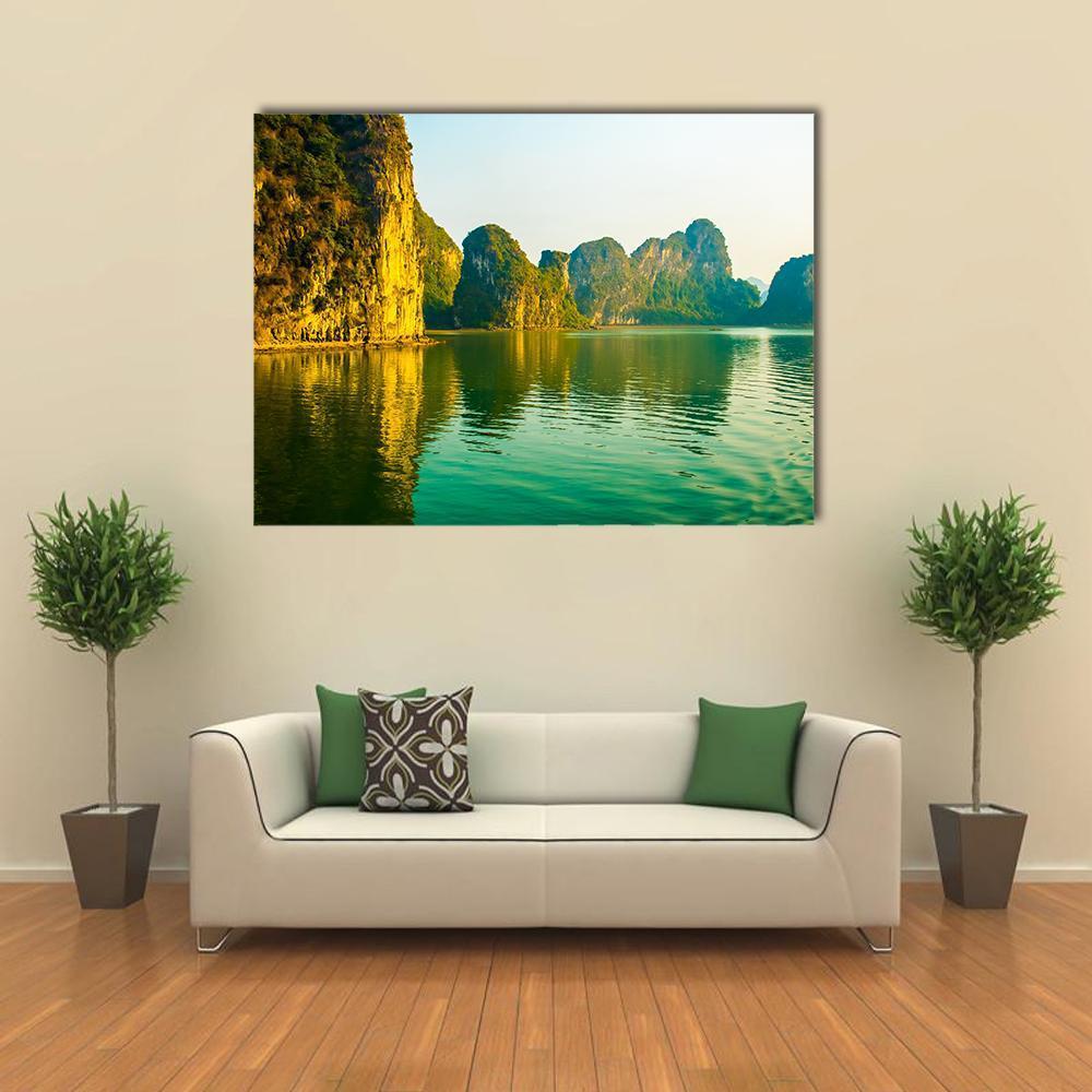 Sunset Over Halong Bay Canvas Wall Art in orange, yellow and green, single panel hung on a wall
