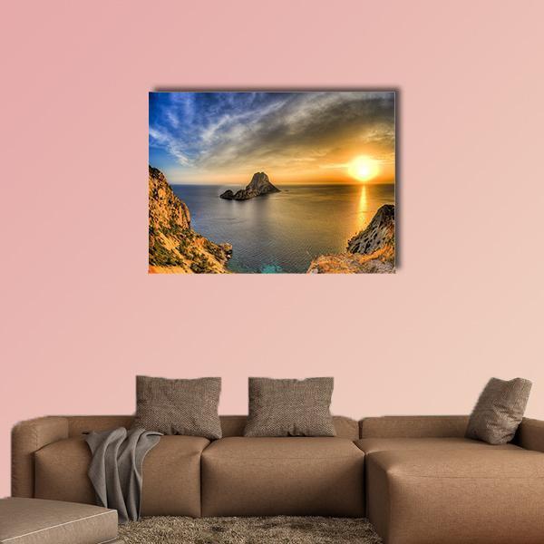 Ibiza Sunset Over Coastal Cliffs Canvas Wall Art in orange, yellow and blue, single panel hung on a wall