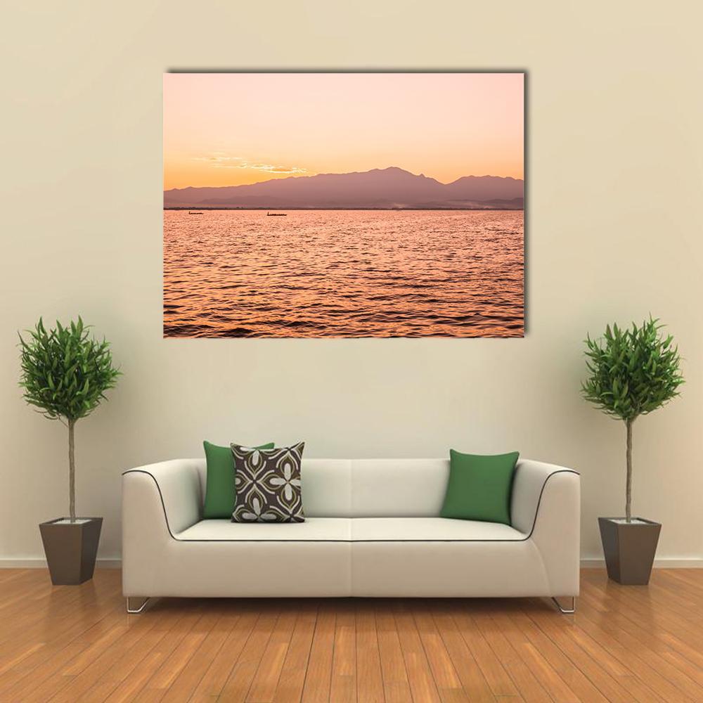 Sunset Over Kwan Phayao Lake Canvas Wall Art in orange, purple and pink, single panel hung on a wall