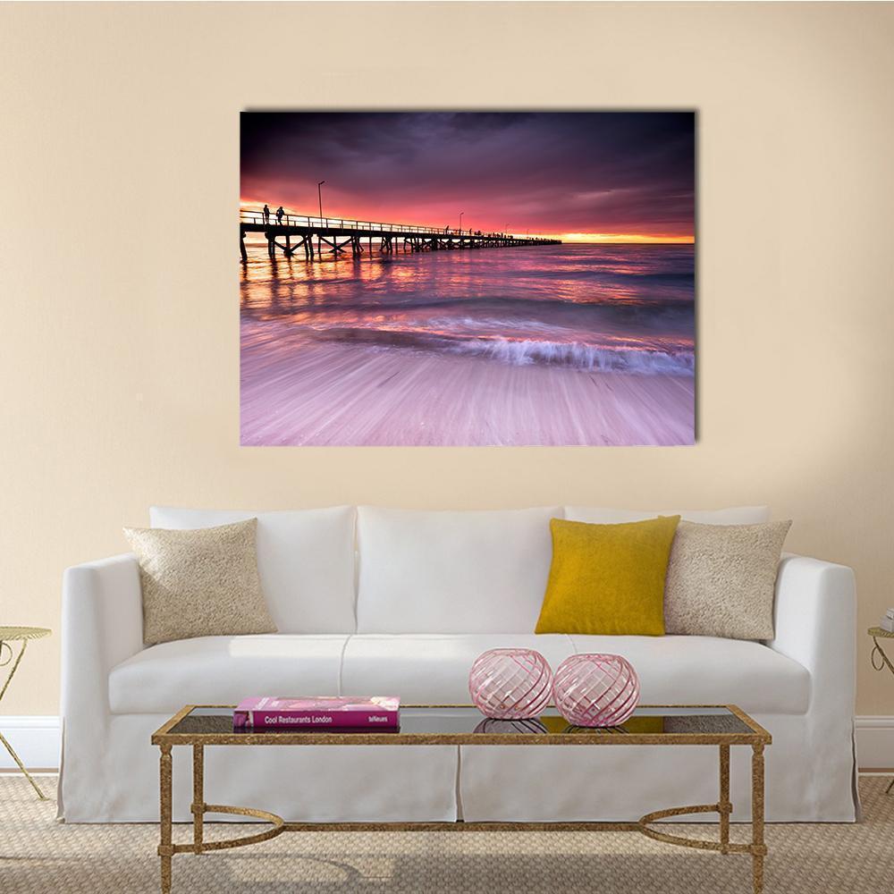 Wooden Pier at Sunset Canvas Wall Art in orange, purple and pink, single panel hung on a wall