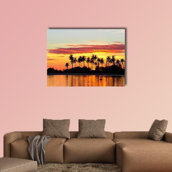 Tropical Island Sunset with Palm Reflections Canvas Wall Art in black, orange and yellow, single panel hung on a wall