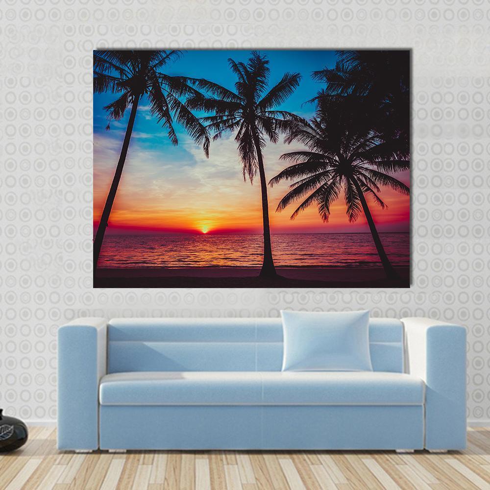Sunset at Tropical Beach Canvas Wall Art in orange, blue and pink, single panel hung on a wall
