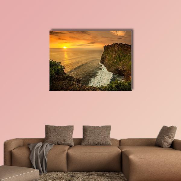 Uluwatu Temple Sunset Canvas Wall Art in brown, orange and yellow, single panel hung on a wall