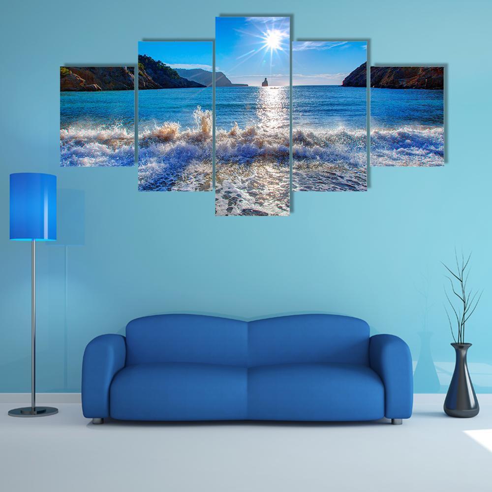 Sunset Beach with Boat on the Horizon Canvas Wall Art in white, orange and blue, 5 panel Star layout hung on a wall