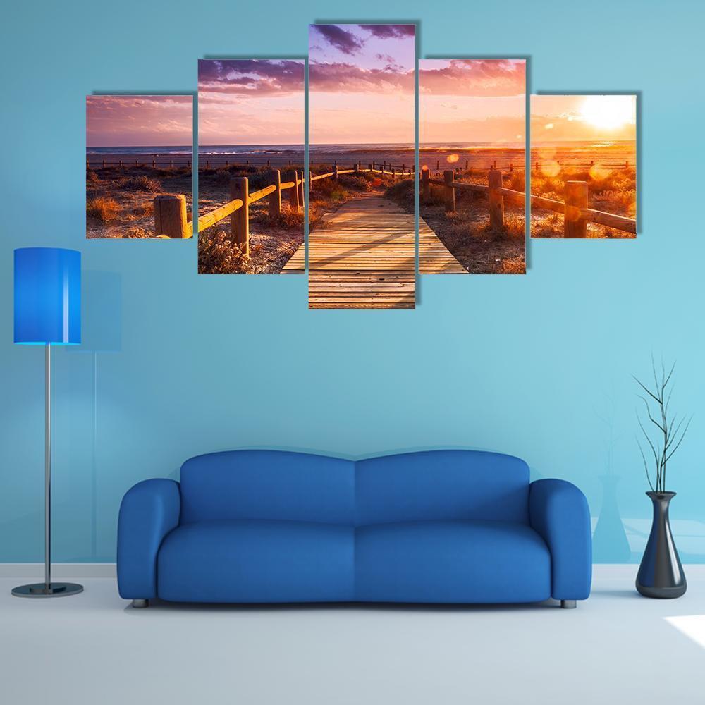 Sunset Boardwalk Near Almeria Canvas Wall Art in orange, blue and purple, 5 panel Star layout hung on a wall