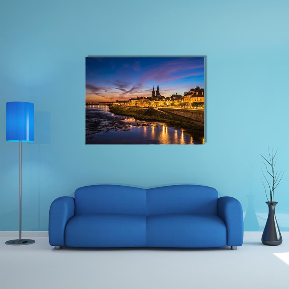 Sunset Cityscape with Cathedral and River Canvas Wall Art in orange, yellow and blue, single panel hung on a wall