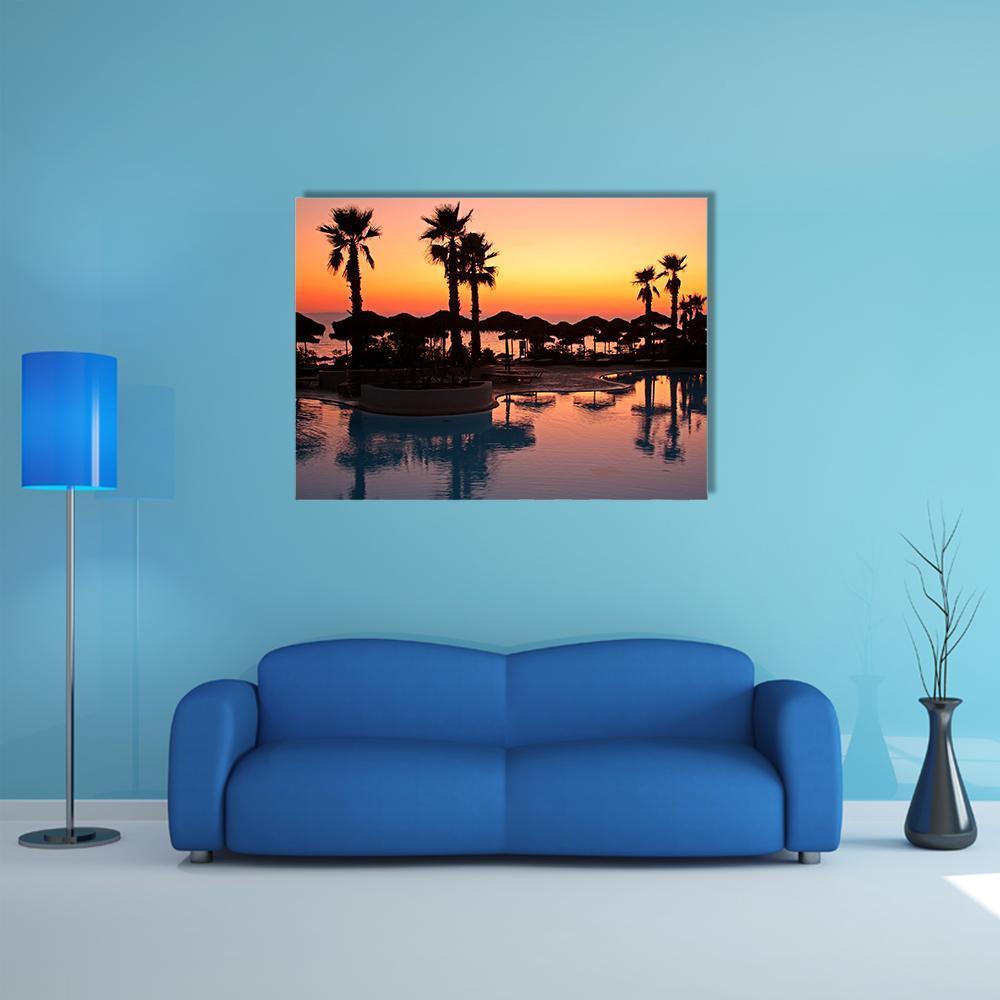 Tropical Resort Sunset Canvas Wall Art in black, orange and blue, single panel hung on a wall