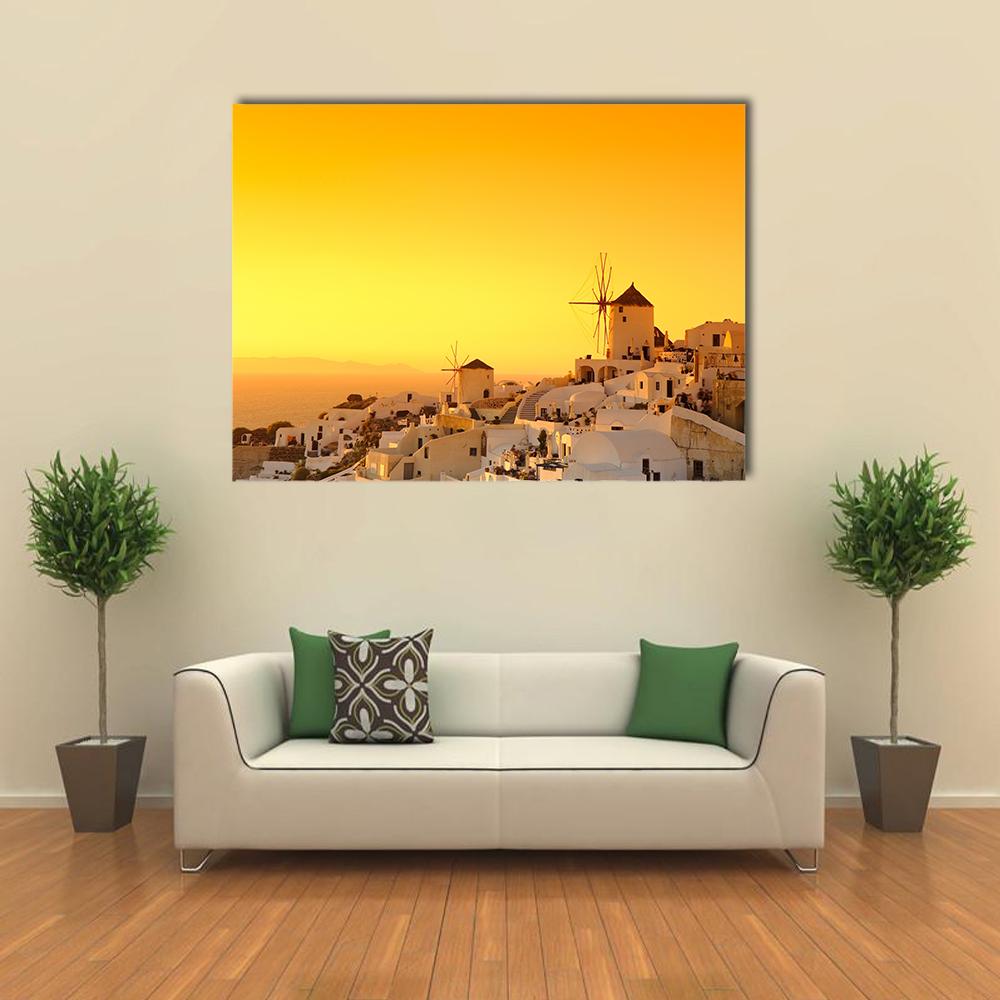 Oia Sunset Over Santorini Village Canvas Wall Art in white, orange and yellow, single panel hung on a wall