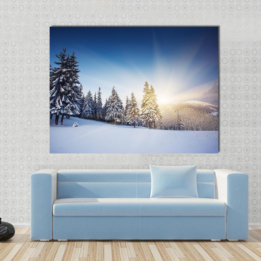 Sunset in the Winter Mountains Canvas Wall Art in white and blue, single panel hung on a wall