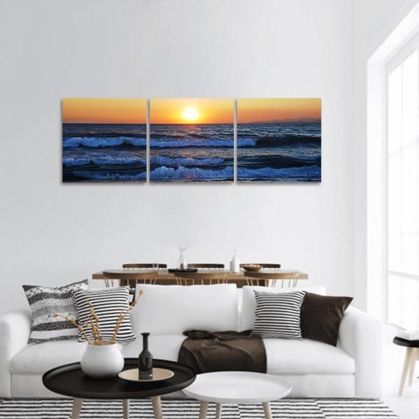 Sunset Over the Aegean Sea Panoramic Canvas Wall Art in orange, yellow and blue, hung on a wall