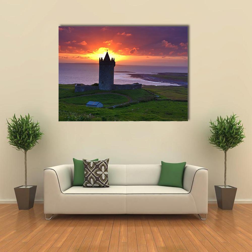 Coastal Castle at Sunset Canvas Wall Art in orange, green and purple, single panel hung on a wall